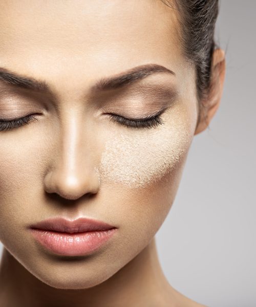 Dry cosmetic makeup powder is on the female face.  Beauty treatment concept. Girl makes makeup.